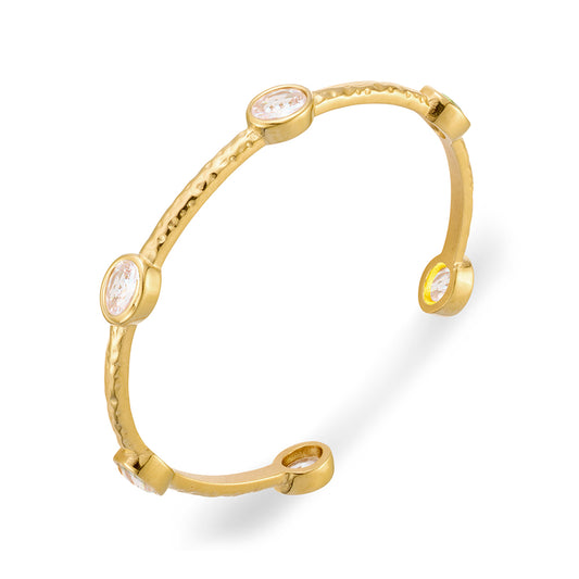 Seren stainless steel gold plated hammered finish cuff bangle with bezel set CZ